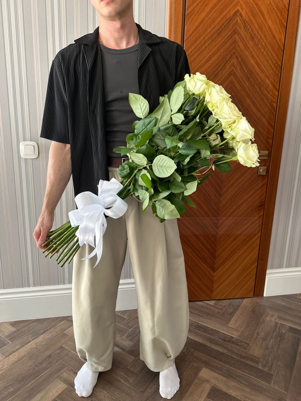 Man with white roses captured in Krasnodar cityscape memories