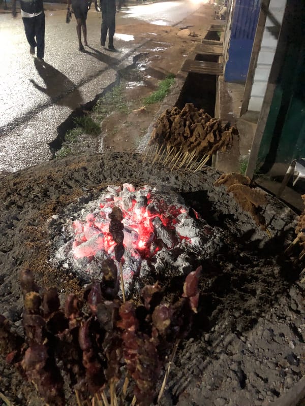 Nighttime street food preparation and indoor blue lighting observed
