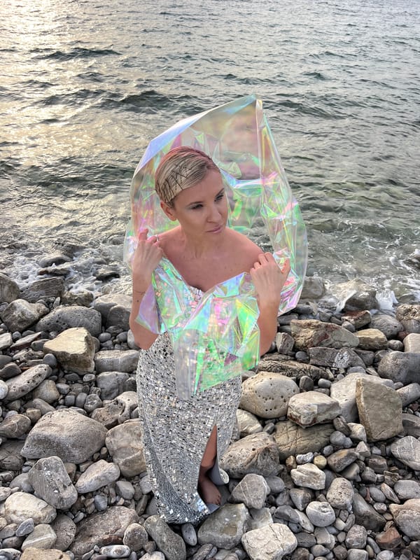 Woman poses on rocky beach in Buljarica, Montenegro