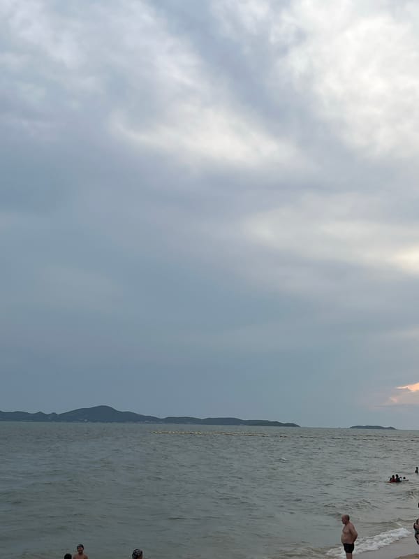 Tourist activities continue at Pattaya beach under cloudy skies
