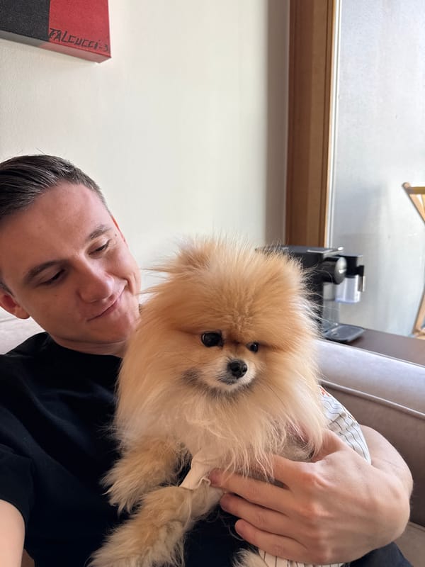Man with Pomeranian dog at Warsaw cafe