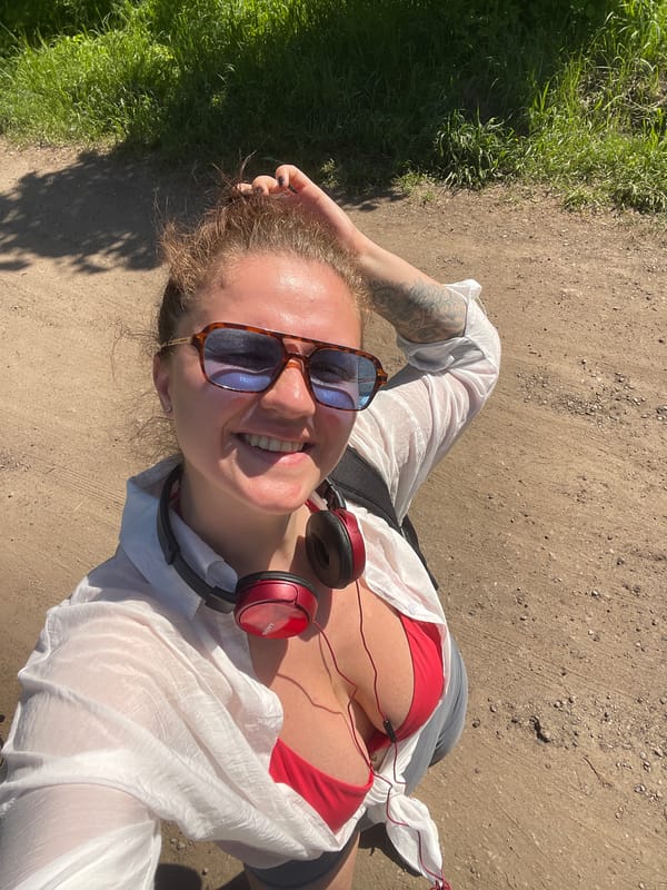Woman rests on dirt path in Ostrov wearing swimwear
