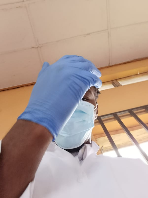 PPE, a wooden sculpture, and lab coats in the same minute
