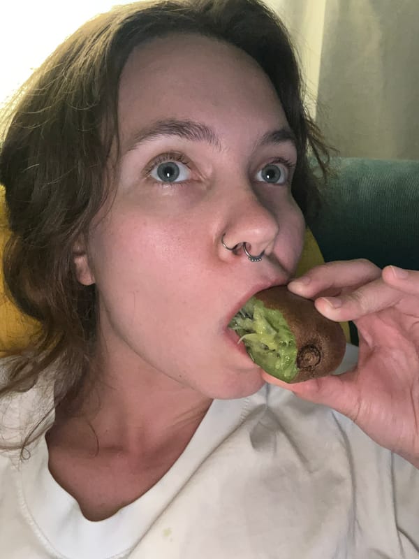Woman eats kiwi fruit in Málaga, Spain