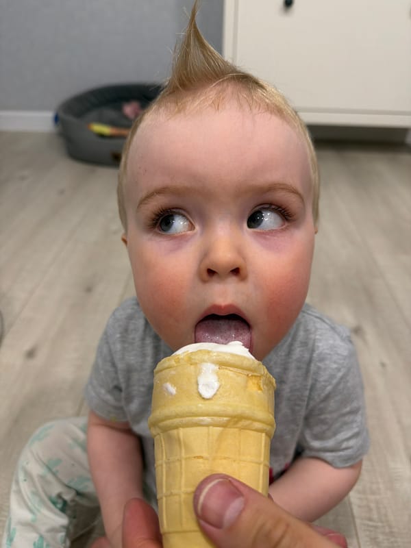 Toddler enjoys snacks at home with pet dog in Votkinsk