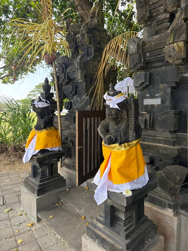 Balinese resort grounds with temples, gardens, and outdoor gym
