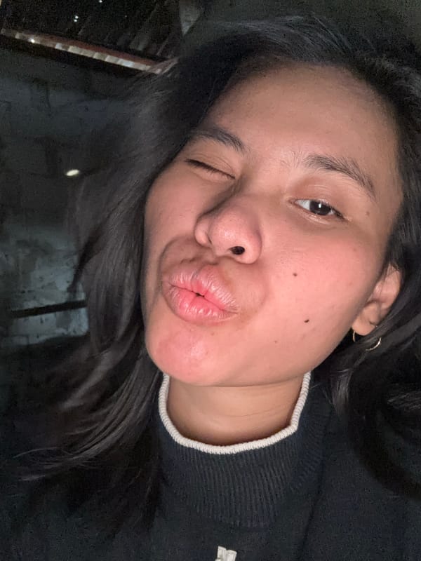 Solo selfie session in a dimly lit East Jakarta room