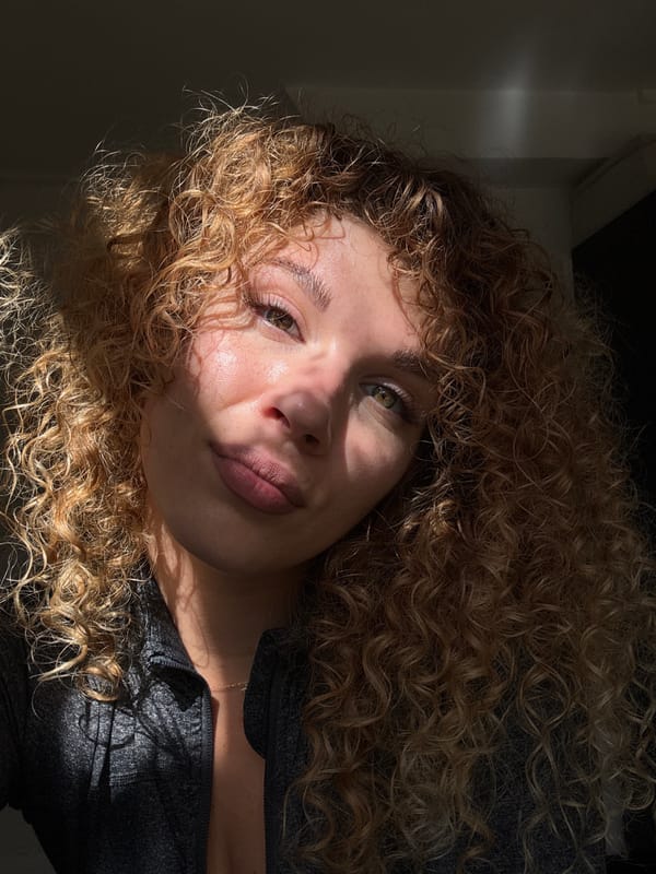 Woman takes selfies in sunlit London room amid plants