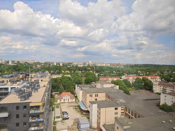 Crane operator documents workday views over Poznan cityscape