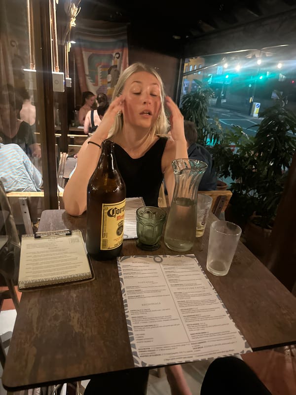 Woman dines with Corona beer at London taco restaurant