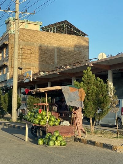 Watermelon vendors work Kandahar streets during afternoon market hours