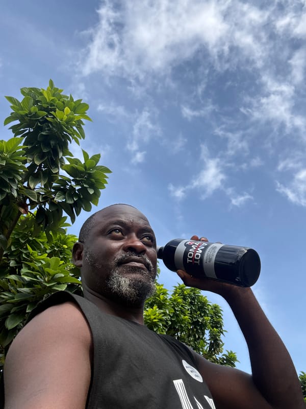 Man holds tomato product bottle in Ado, Nigeria