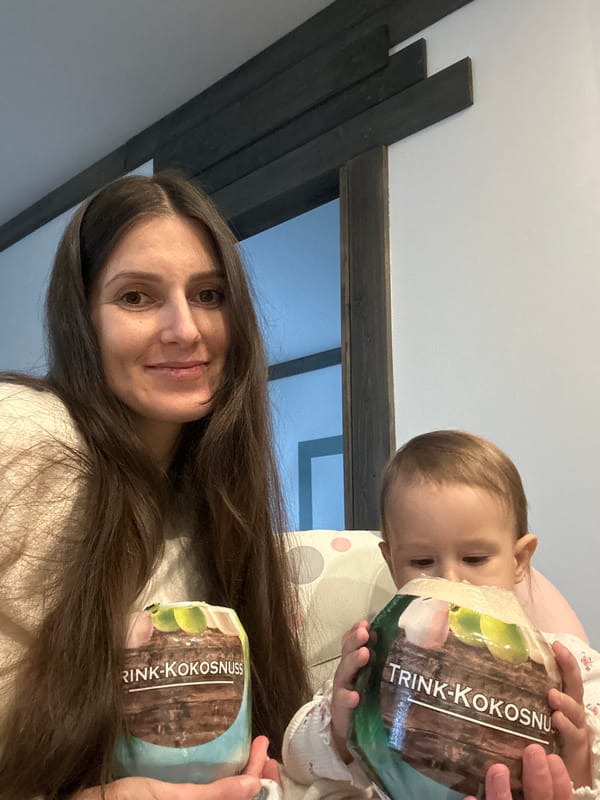 Mother and child share moment with coconut drink