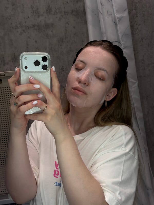 Woman documents morning self-care routine with face mask and breakfast