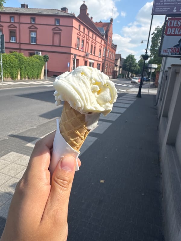 Ice cream enjoyed on sidewalk in Buk, Poland