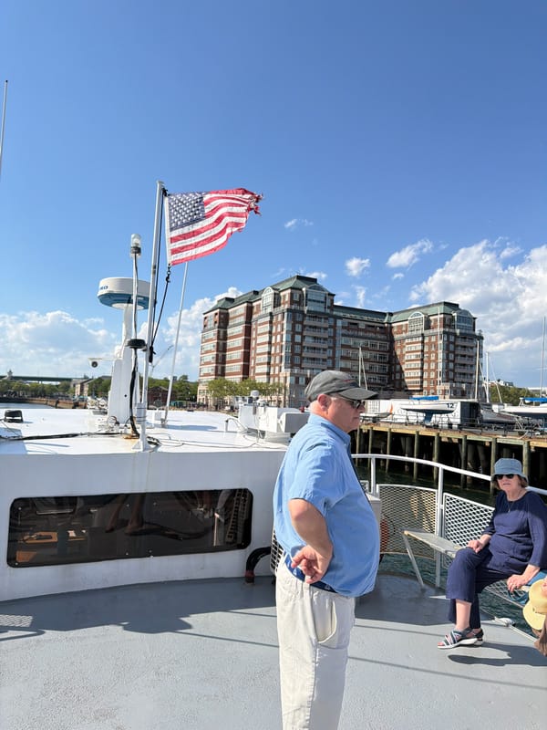 Boat with weathered flag observed in Boston harbor