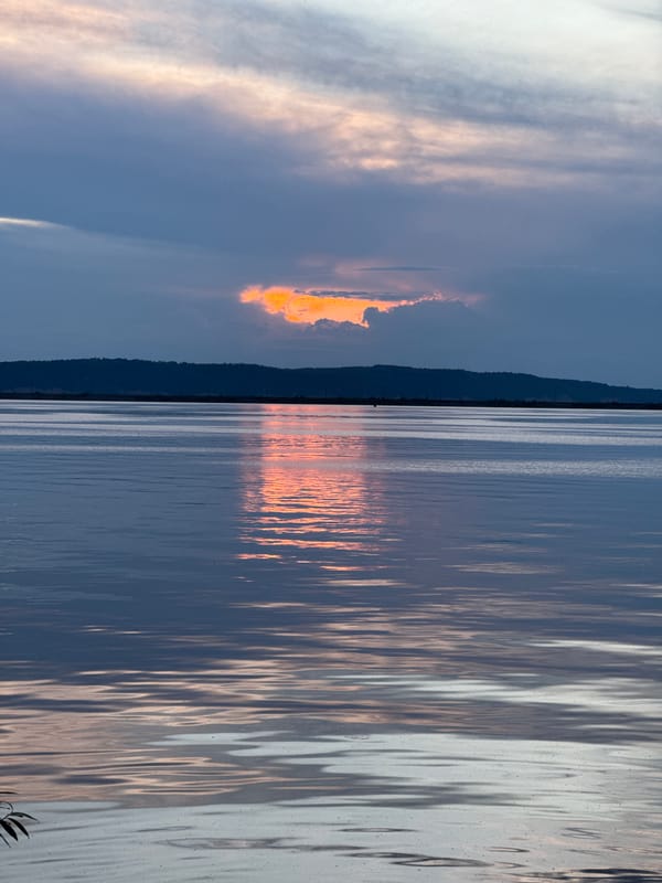 Dramatic sunset captured over serene water body