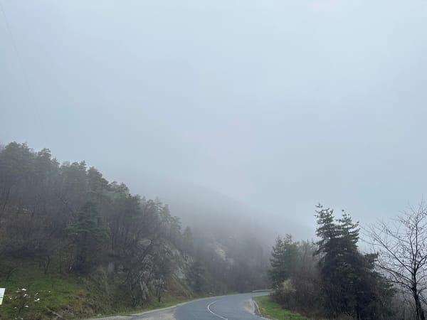 Foggy morning conditions on winding road in Komuniga Bulgaria