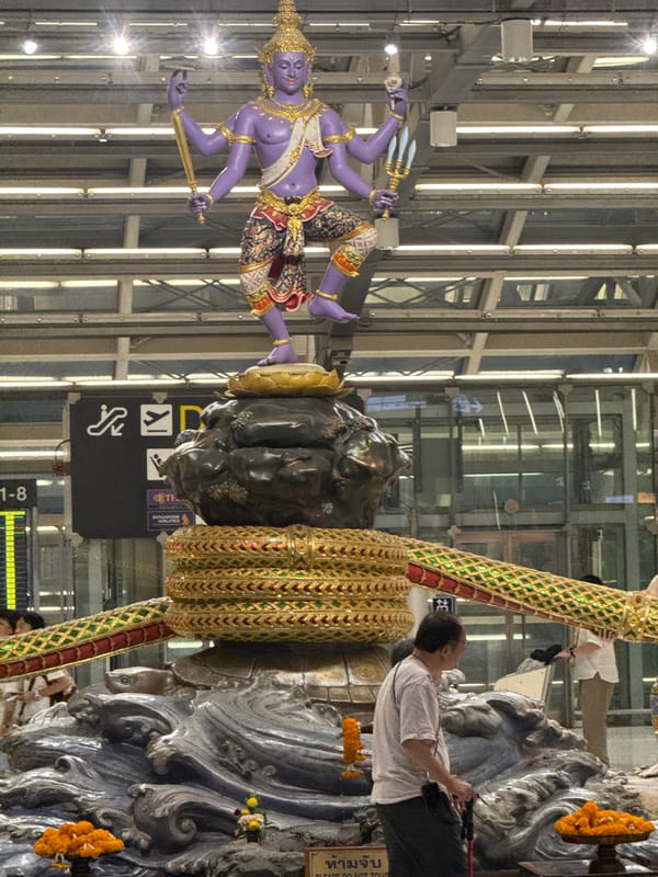 Layover at Suvarnabhumi, with Hindu sculptures and departure boards