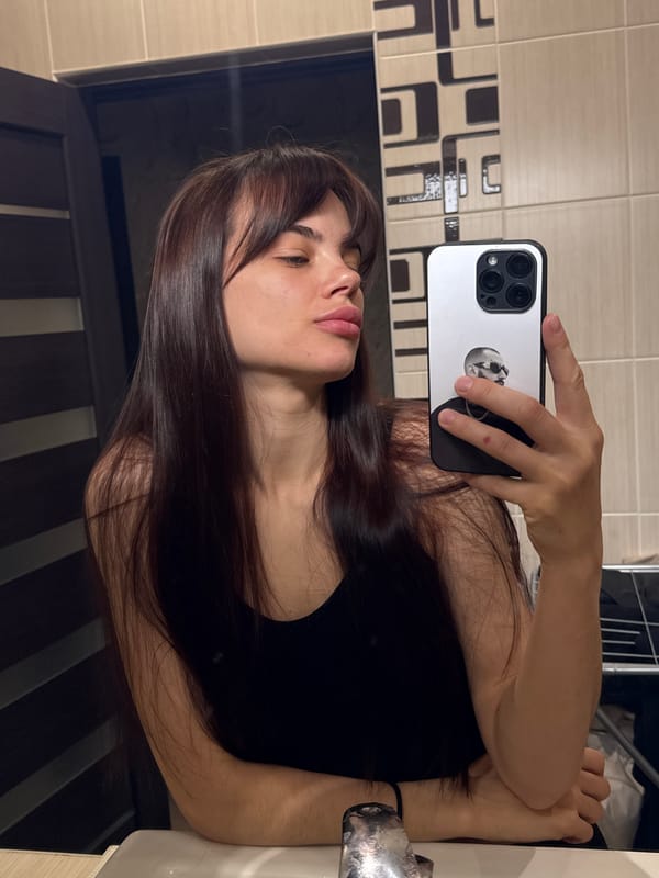 Young woman takes multiple bathroom mirror selfies in Rostov-on-Don