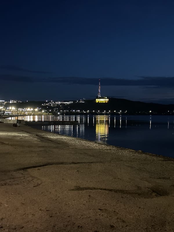 Twilight settles over Kokshetau Bay, sailboat on calm water