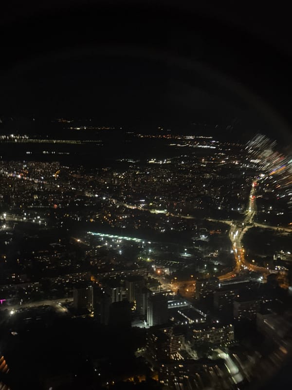 Sofia at night, seen from above through blurred city lights.