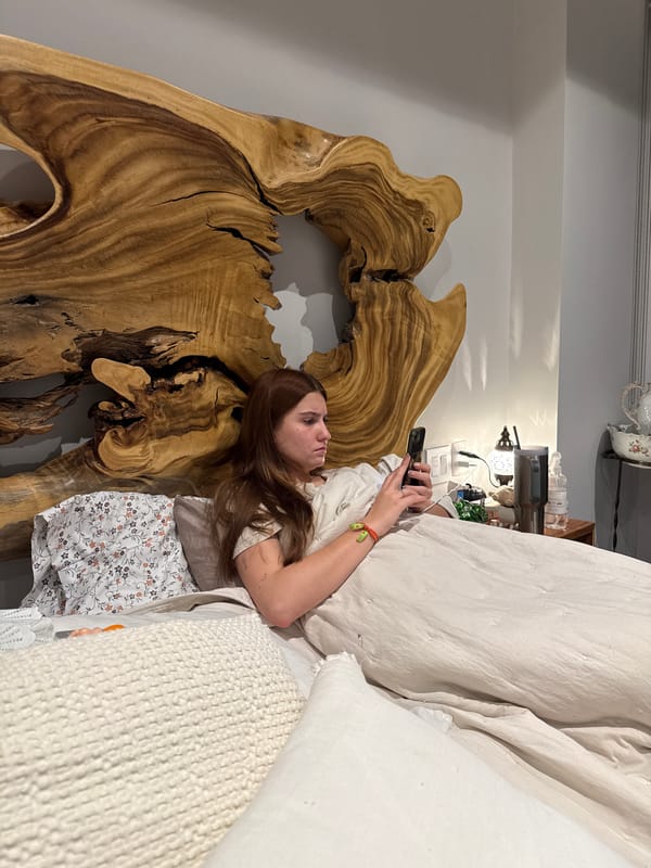 Woman uses smartphone in bed during early morning hours