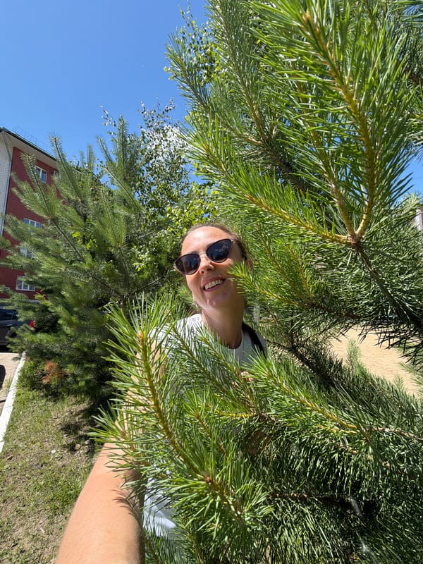 Selfie session among pine trees on a sunny Birobidzhan afternoon