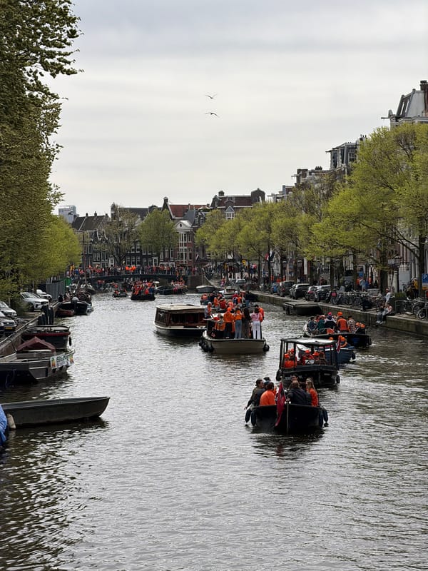 Orange-clad crowds celebrate on Amsterdam canals during festive gathering