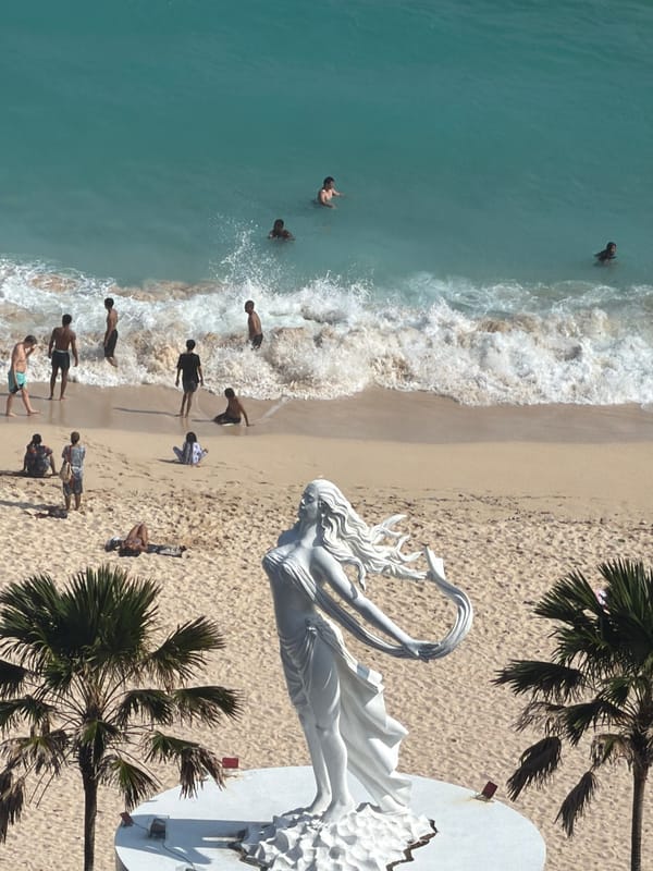 Tourists capture scenic Bali coastal views and statues