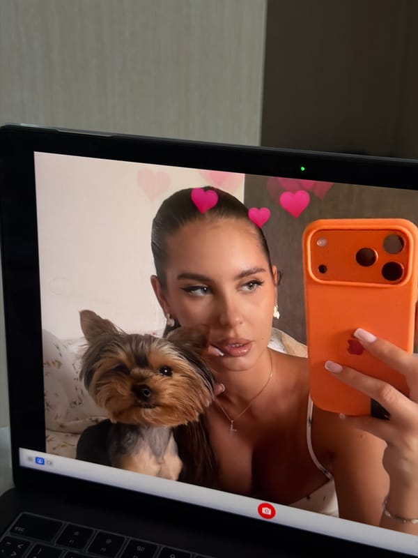 Woman's selfie with dog displayed on laptop screen in Krasnoyarsk