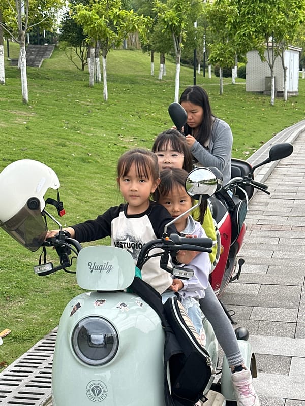 Children gather around parked scooters in Jiangjin
