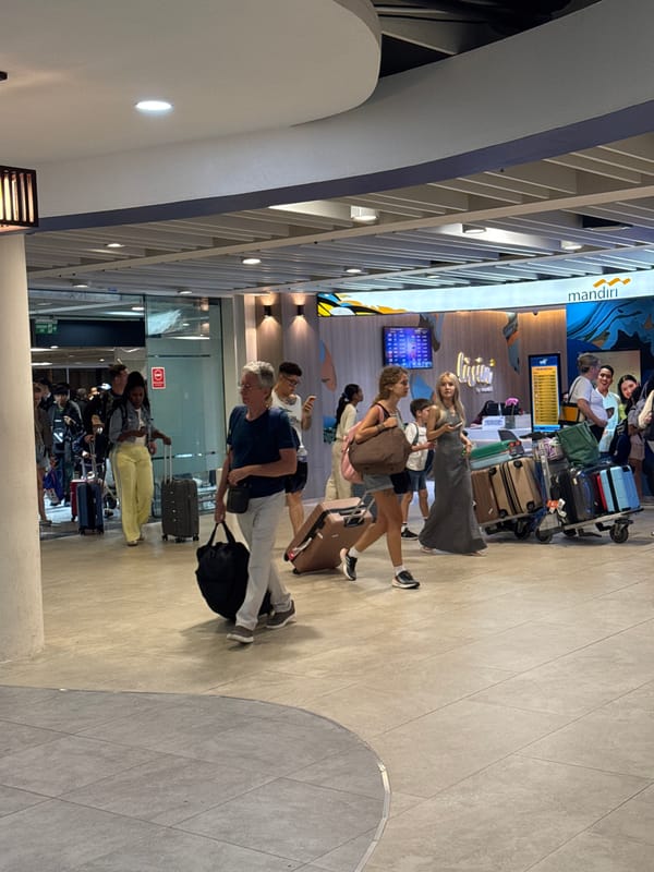 Busy afternoon foot traffic through Bali's Ngurah Rai Airport terminal