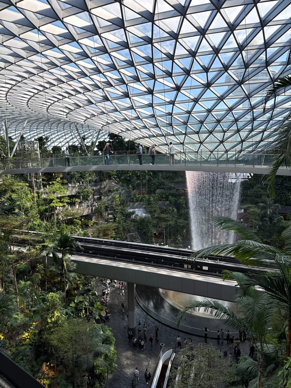 Visitors document Rain Vortex waterfall at Singapore's Jewel Changi Airport