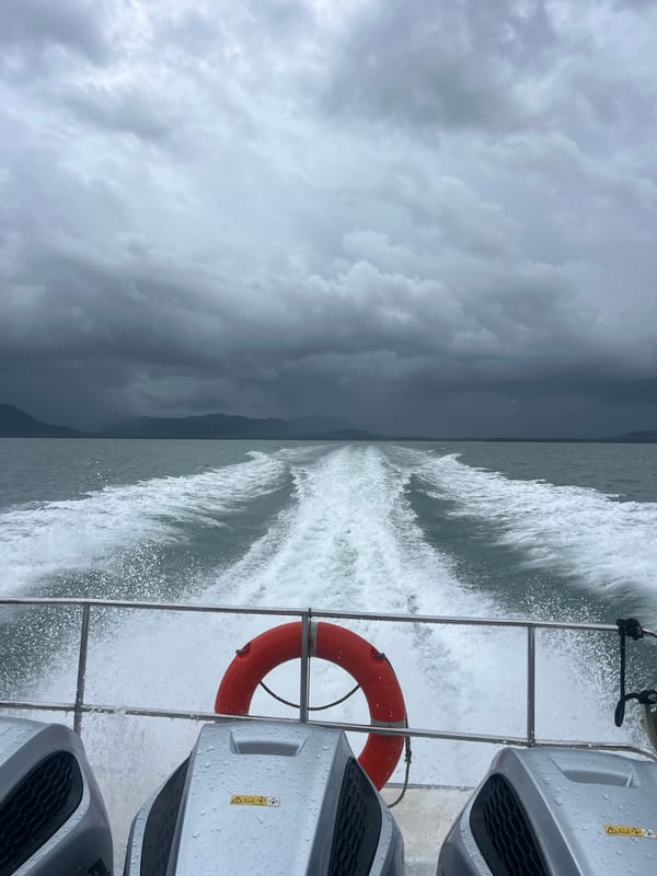 Twin outboard motors pushing through rough Thai coastal waters