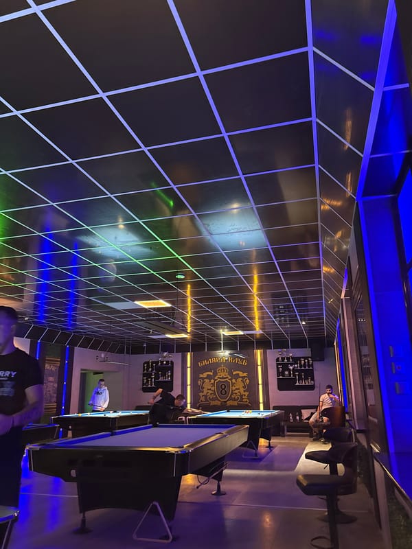 Men play pool at billiard club in Ruse, Bulgaria