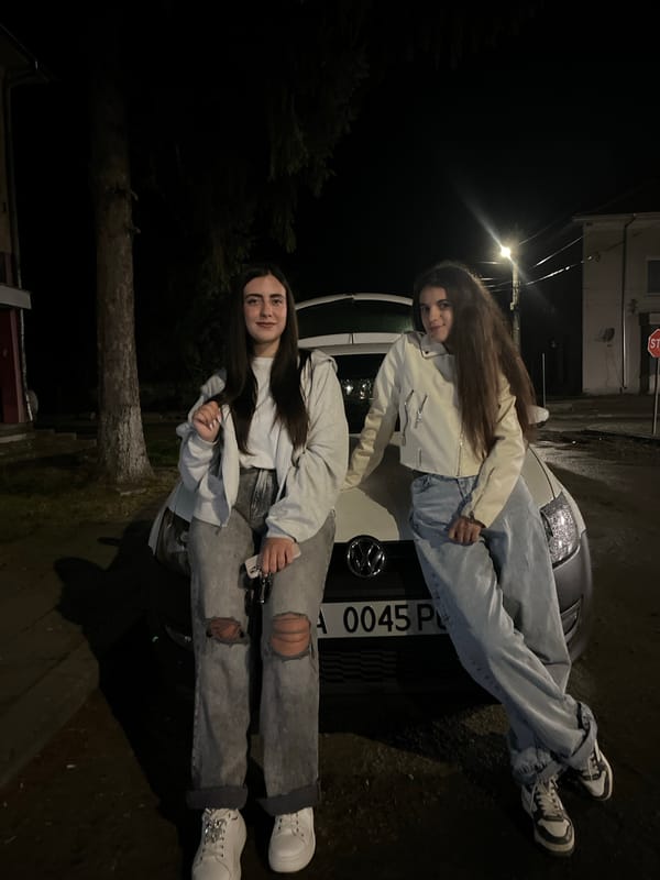 Young people pose with car during nighttime gathering in Bulgaria
