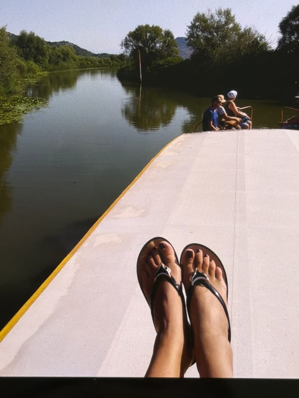 Boat trip through calm waterways beneath green hills