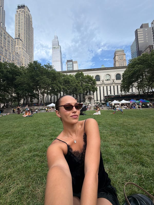 Woman takes selfie on Bryant Park lawn Friday evening