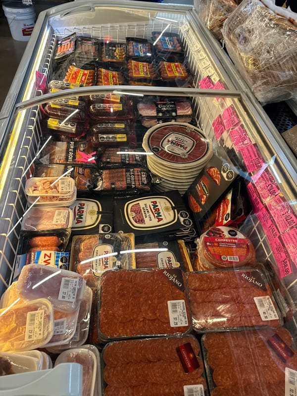 Stocked meat display case observed at Puebla grocery store