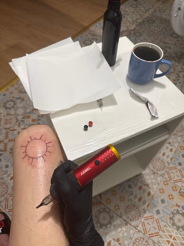 Tattoo session documented in Sofia evening cityscape