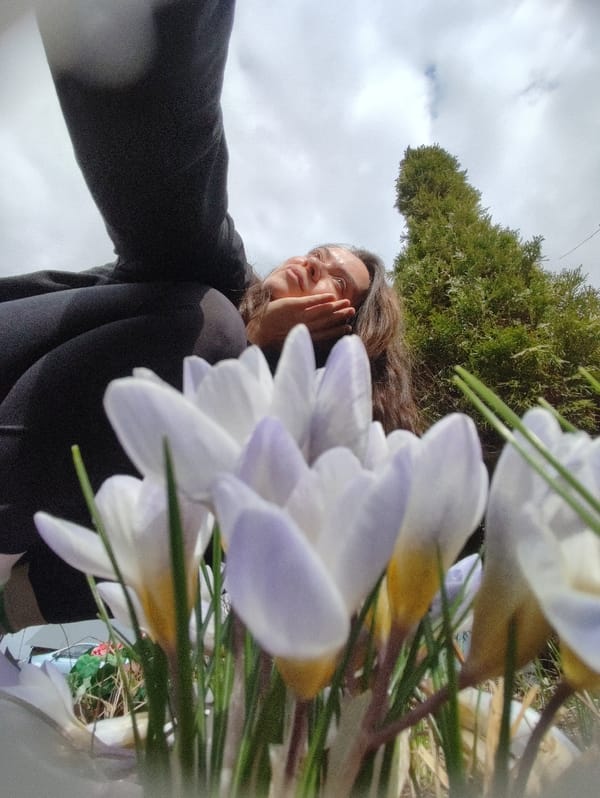 Woman documents spring morning with flowers and outdoor cooking