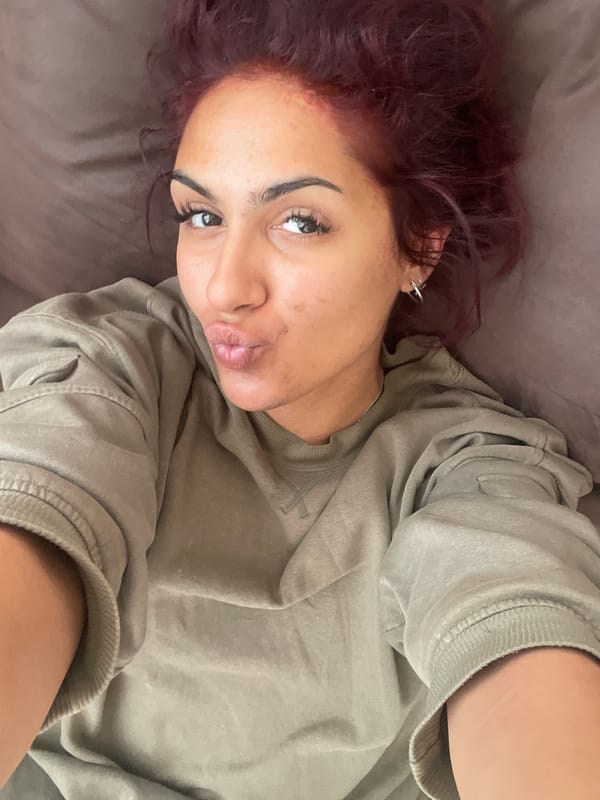 Woman with purple hair spotted with chocolate bunny