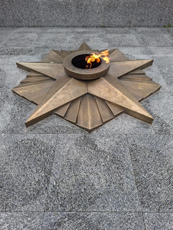 Kokshetau memorial park: wet flowers, fountain, and war monument