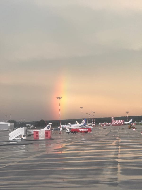 Rainbow over a wet Koltsovo Airport tarmac after summer rain