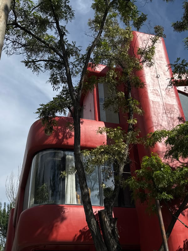 Red building and waterfront boat documented in Yerevan