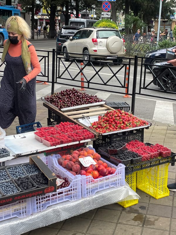 Fresh fruit stall on a Sochi sidewalk, summer market scene