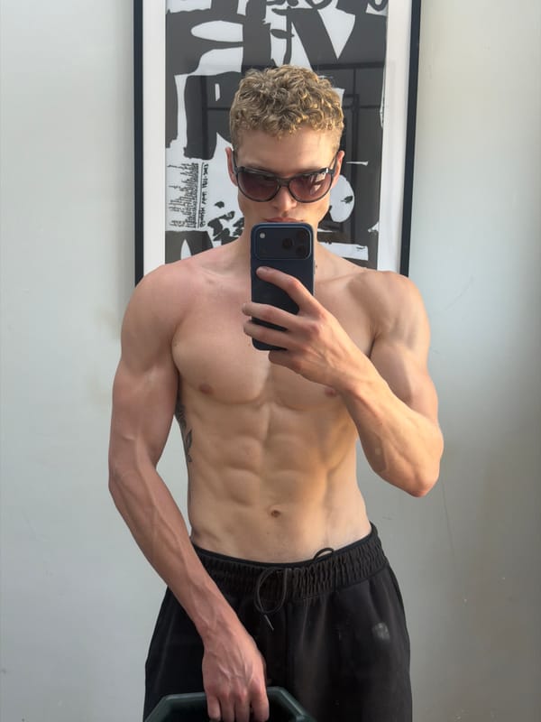 Mirror selfie in a London home gym, July 2026