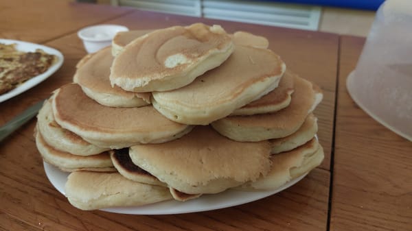 Stack of homemade pancakes on a wooden table in Salsk