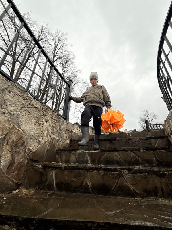 Mother and child share umbrella moment in rainy Dmitrov
